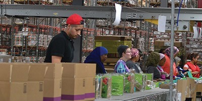 Workers in a co-packing warehouse assembly line