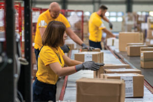 Co-pack production line woman packaging boxes warehouse